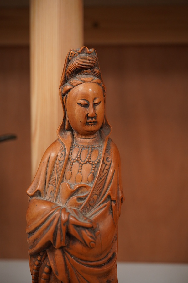 Two Chinese carved boxwood figures, one of Shao Lao, the other of Guan Yin, both on stands, on stands. tallest 26cm